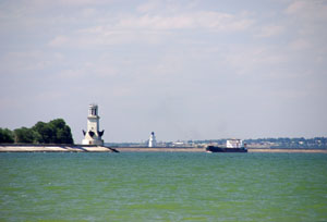 Ориентируясь на маяк, к порту приближается грузовое судно